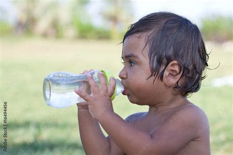 Bambino che beve dal biberon con tettarella Nuby