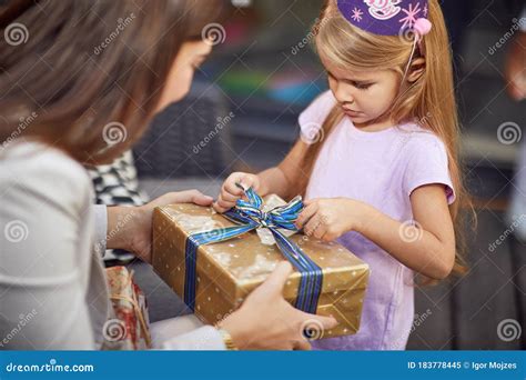 Bambina che apre un regalo di compleanno
