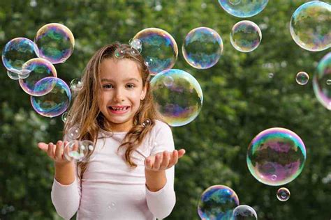 Bambini che inseguono bolle di sapone