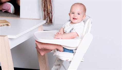 bambino seduto su un seggiolone con riduttore