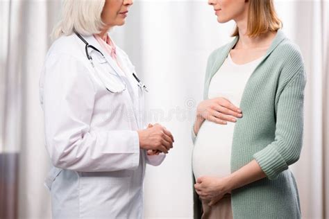 Medico che parla con una donna incinta