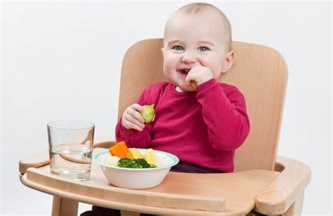 Bambino che mangia frutta durante lo svezzamento