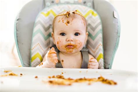 Bambino piccolo che mangia con un cucchiaino